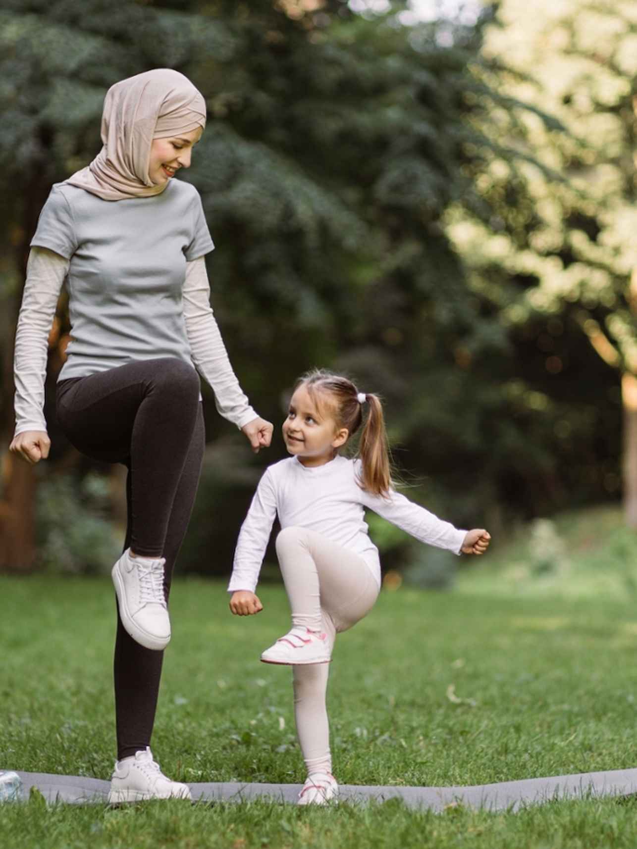 vrouw moeder kind meisje sporten park grasveld hva