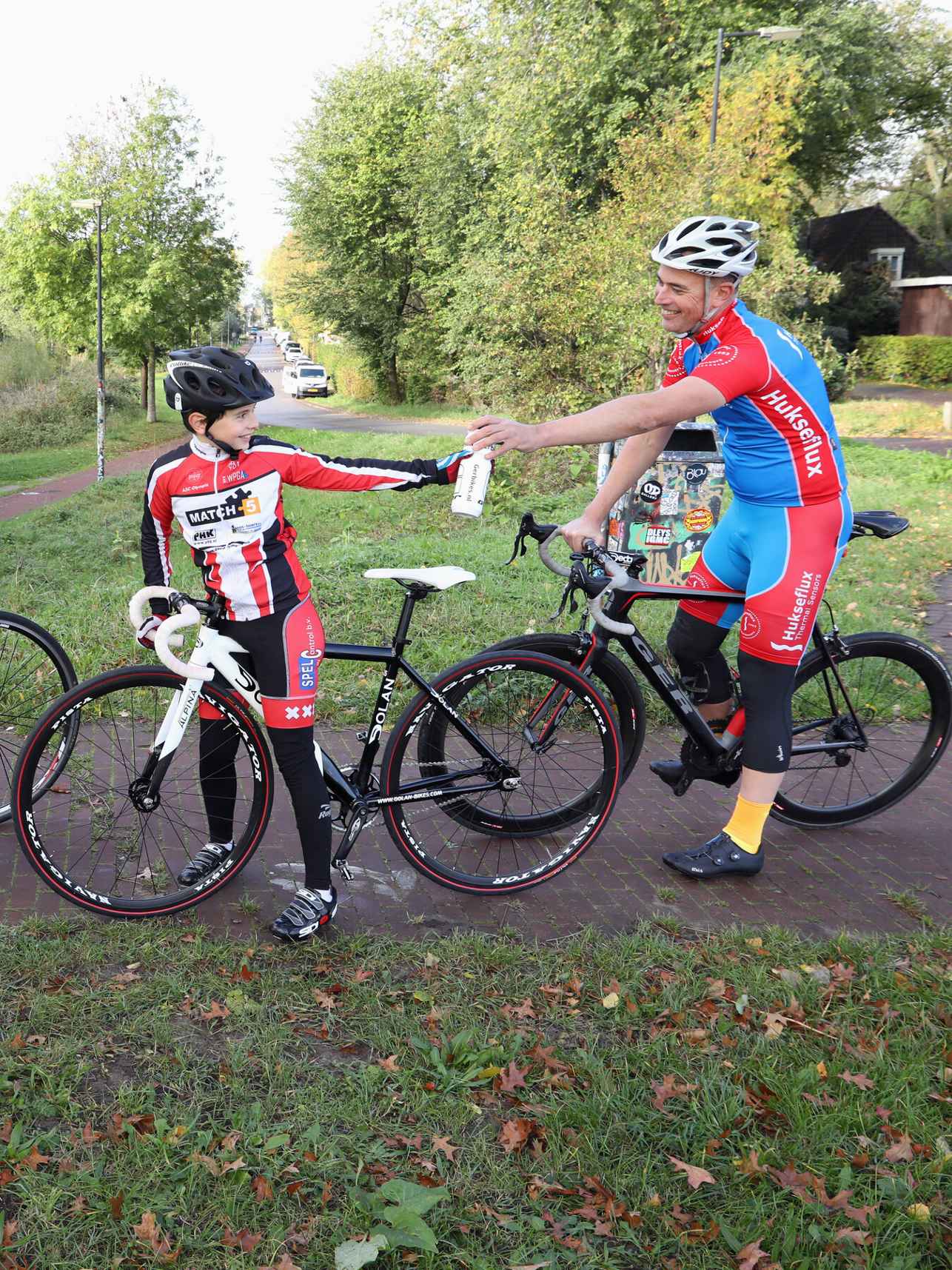 vader met zoon en dochter wielrennen in park