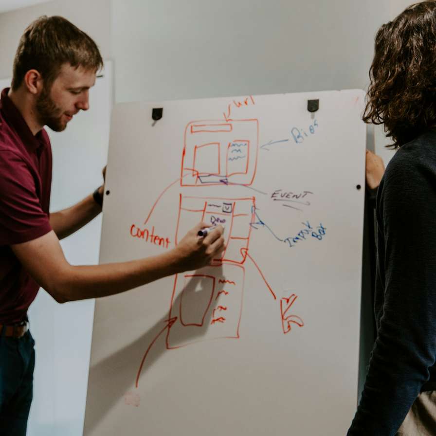 Person writing on whiteboard.