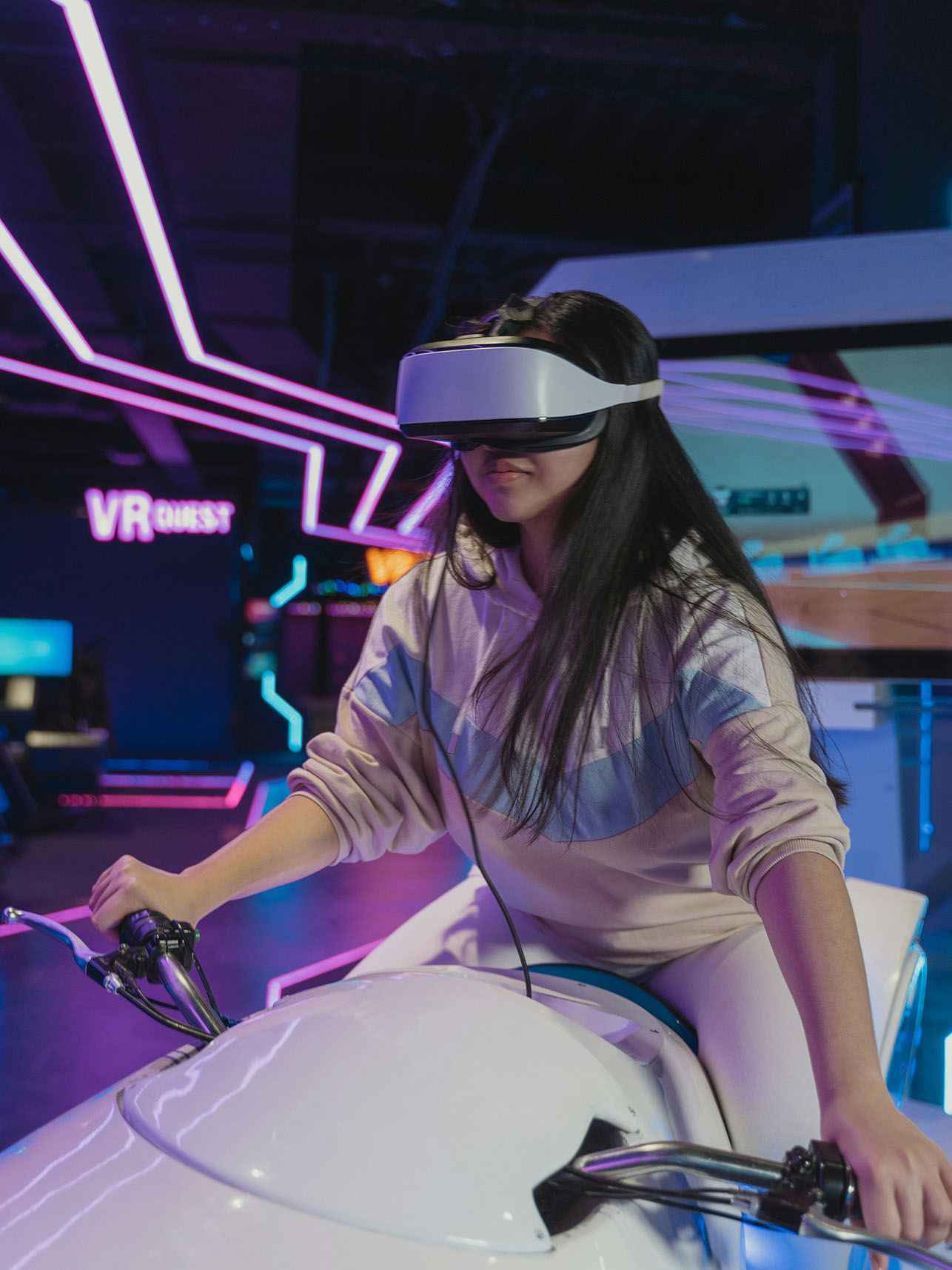 Girl with VR glasses on a motorcycle.