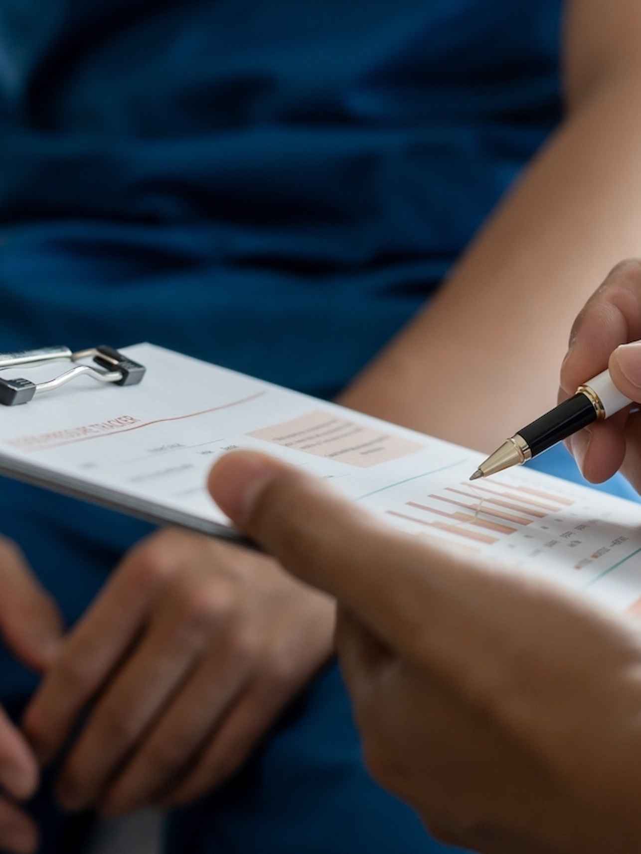 Caregiver in hospital filling out a form