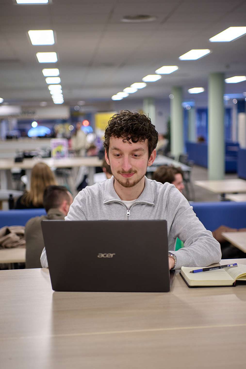 male student master sport business and leadership auas behind laptop
