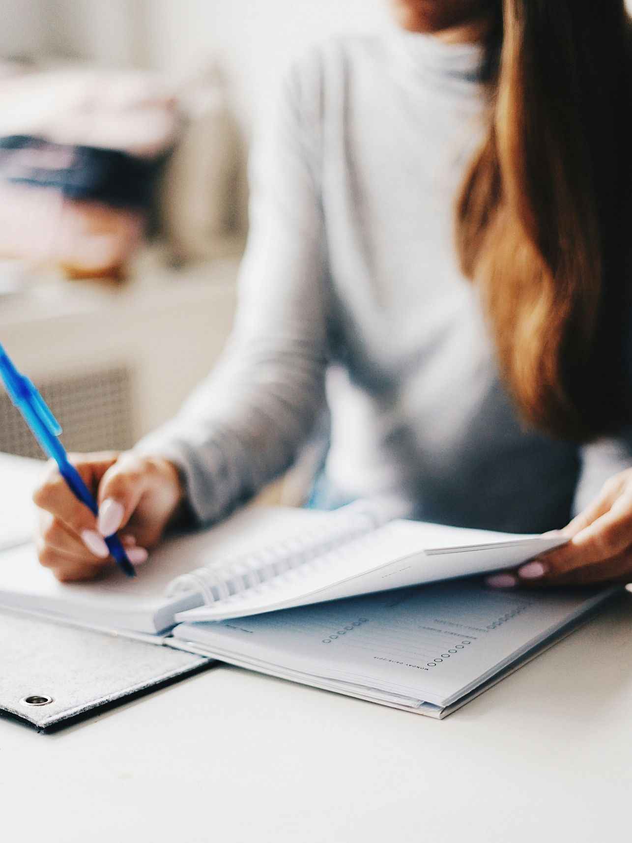 Girl writing in notebook.