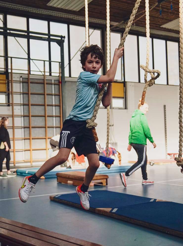 jongetje in gymzaal in touwen HvA project Met een glimlacht de gymles uit