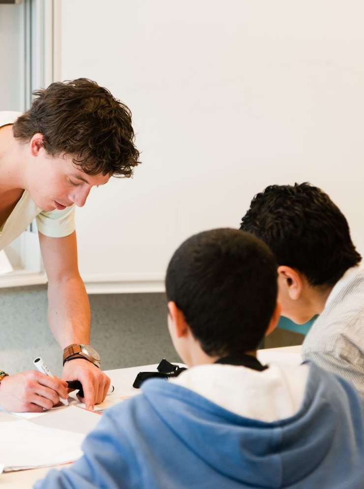 docent helpt leerlingen met studie